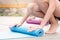 Woman roll out yoga mat and preparing to meditate training in yoga class session with her friend