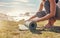 Woman, roll yoga mat and beach for meditation, outdoor and peace to relax or for wellness. African American female