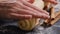 Woman rolling out dough for buns with cinnamon