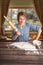 Woman with rolling-pin in the kitchen, bright emotional portrait