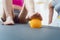 Woman rolling spiked ball under her feet in physical therapy