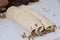 A woman rolls up the rolled dough with a layer of walnuts. Cooking buns