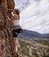 Woman, rope and rock climbing for fitness in outdoors, challenge and mountain for training. Female person, cliff and