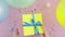 Woman rotates Christmas birthday gift box wrapped in yellow paper with blue bow on pink table