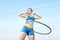 Woman rotates hula hoop