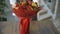 Woman rotating bouquet of fruits: lime, strawberry, pomegranate, marshmallow, apple