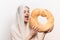 woman with round loaf of bread loaf model with transparent cloth on her head