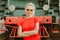 Woman in round stylish glasses stands in front of a train. Self-confidence, assertiveness