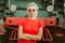 Woman in round stylish glasses stands in front of a train. Self-confidence, assertiveness