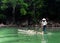 A woman rowing boat on Ba Be lake in Bac Kan, Vietnam