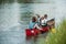 Woman rowing with childreen in the channel in yellow kayak