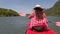 Woman rowing kayaking in lagoon action camera pov back rear view of girl paddling on kayak boat