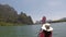 Woman rowing kayaking in lagoon action camera pov back rear view of girl paddling on kayak boat