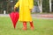 Woman in rubber boots wearing yellow coat