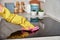 Woman in rubber gloves cleaning induction stove