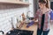 Woman in rubber gloves cleaning kitchen table.