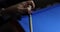 Woman rubs end of cue using special billiard chalk at table