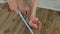 A woman rubs her heels with a double-sided foot grater. The female cleans her feet with a grater, removing calluses