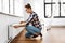 woman with ruler measuring heater at home