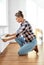 woman with ruler measuring heater at home