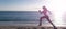 Woman run and jump on sea beach. Energetic running woman in activewear run on beach sand along seaside, runner.