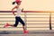 Woman runner athlete running at seaside road
