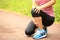 Woman runner holder her sports injured knee