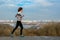 Woman runner jogging with beautiful city view, running outdoors