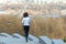 Woman runner jogging with beautiful city view, running outdoors