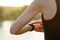 Woman Runner Resting on the Trail at Sunset and Using Smartwatch. Closeup of Hands with Smart Watch. Sports Concept