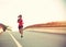 Woman runner running on city bridge road