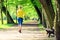 Woman runner running jogging in green summer park and woods