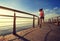 woman runner running on sunrise seaside boardwalk