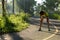 Woman runner take a break at morning tropical forest trail