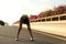 Woman runner take a rest on city bridge road