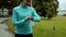 Woman runner using smart watch fitness tracker in green autumn forest