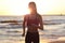 Woman running alone at beautiful dusk on the beach