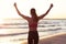 Woman running alone at beautiful dusk on the beach