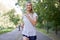 Woman running asphalt road summer park