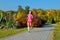 Woman running in autumn park, beautiful girl runner jogging