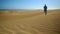 A woman running away into the desert in slow motion