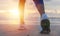 Woman running on the beach at sunrise closeup on shoe. Patong be