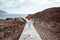 Woman running on the beautiful wavy pathway near the ocean