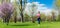 Woman running for better fitness though a park in spring