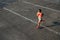 Woman running on city asphalt