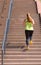 Woman running while climbing stairs during workout
