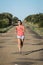 Woman running on country asphalt road