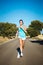 Woman running countryside road