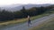 Woman Running on a Countryside Road at Sunset.