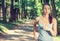 Woman running In countryside wearing earphones